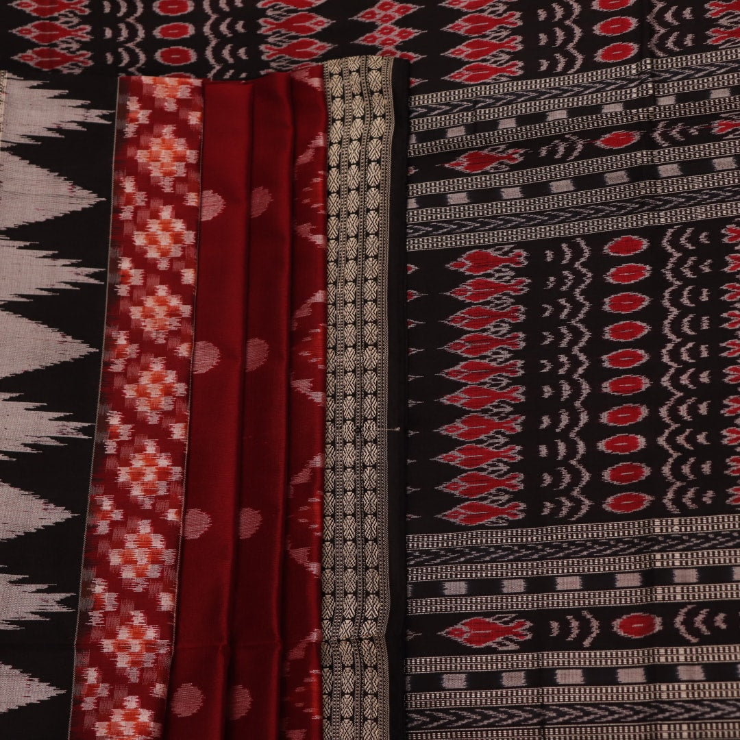 Close-up view of maroon and black silk Sambalpuri saree fabric showcasing intricate motifs