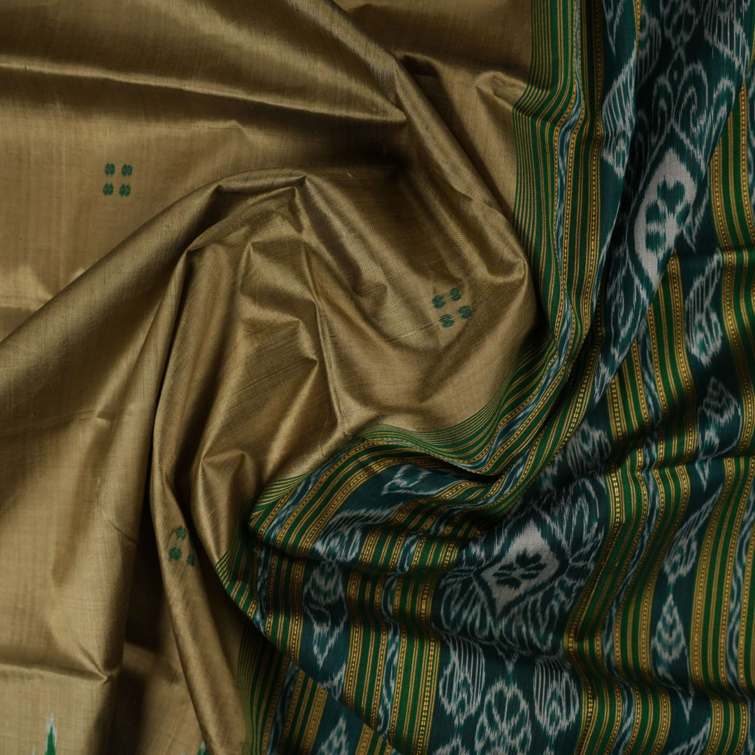 Elegant styling of a brown and green Khandua silk saree with butta work as draped on a model.