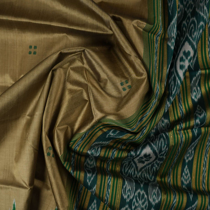 Elegant styling of a brown and green Khandua silk saree with butta work as draped on a model.
