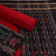 Detail of the black Sambalpuri cotton dress material's blouse piece with red motifs.