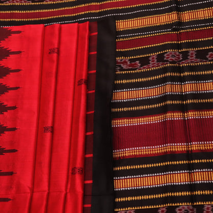 Textured close-up of red and black Sambalpuri Silk Saree fabric, highlighting the woven butta pattern.