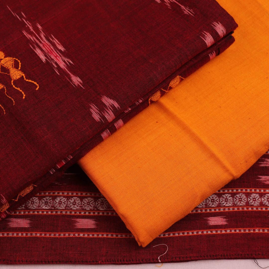 Close-up of yellow doll pattern on maroon cotton Sambalpuri dress material blouse piece