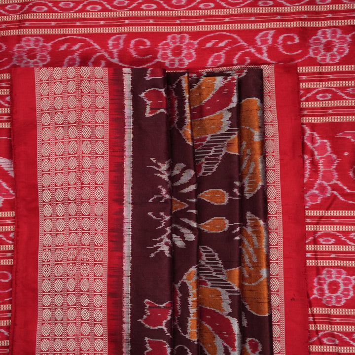 Close-up of the maroon Sambalpuri silk saree fabric, highlighting its luxurious texture and intricate weave.
