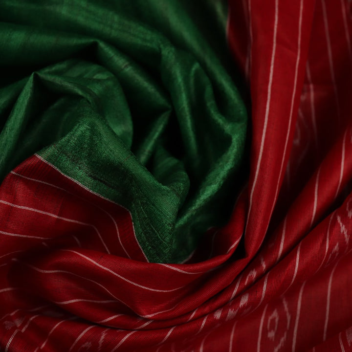 Close-up of green and red tussar silk saree fabric texture