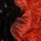 Full view of a black and orange Bomkai cotton handloom saree with butta pattern.