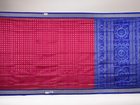 Close-up of Sambalpuri silk fabric texture, revealing the fine handloom weave and quality.