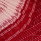 White and red cotton Sambalpuri Saree with motifs, elegantly draped.