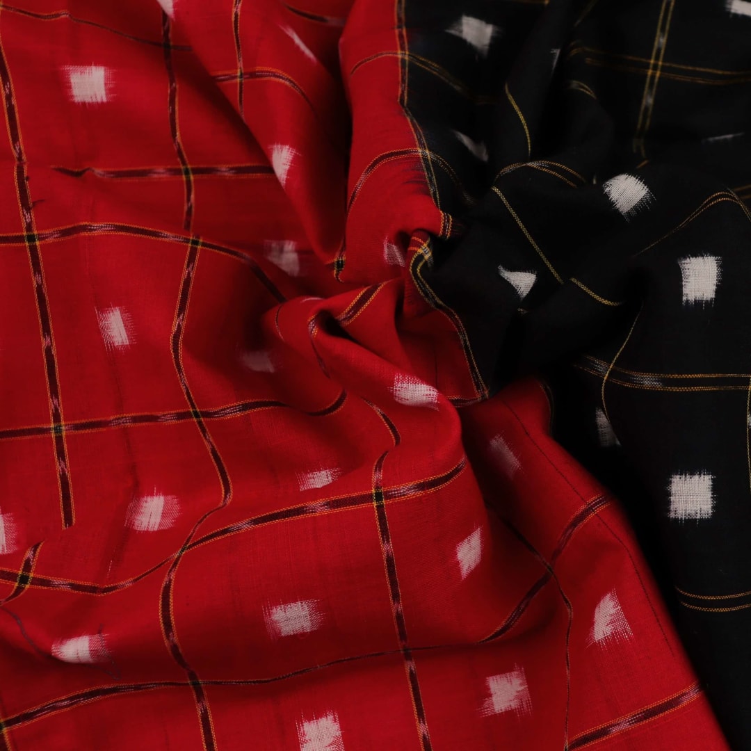 Red and black Sambalpuri cotton dupatta with intricate motifs, styled elegantly