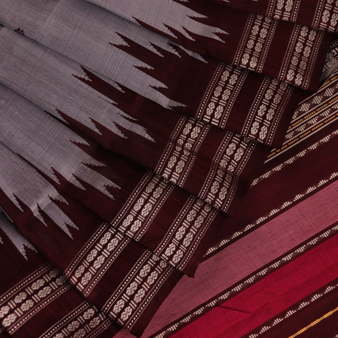 Close-up of silk fabric texture with butta design in grey and maroon