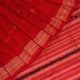 Close-up of the distinct handwoven texture of a red Sambalpuri silk saree with Butta pattern.