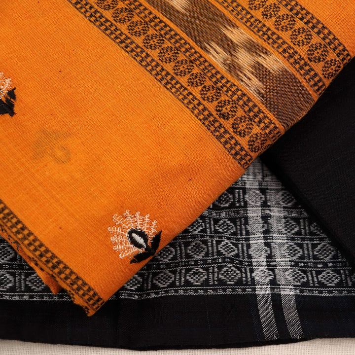 Close-up details of blouse piece with yellow and black motifs and embroidery on cotton Sambalpuri material