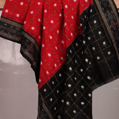 Red and black Sambalpuri cotton dupatta with intricate motifs, styled elegantly