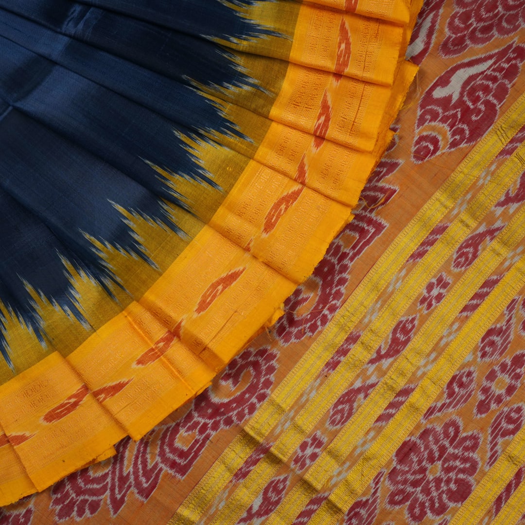 Model styling a blue and yellow Khandua silk saree with traditional butta work and border.