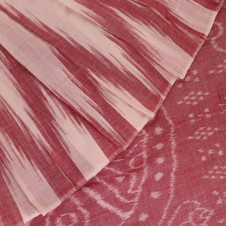 Plain white and maroon Sambalpuri cotton saree styled to show its drape and color combination.