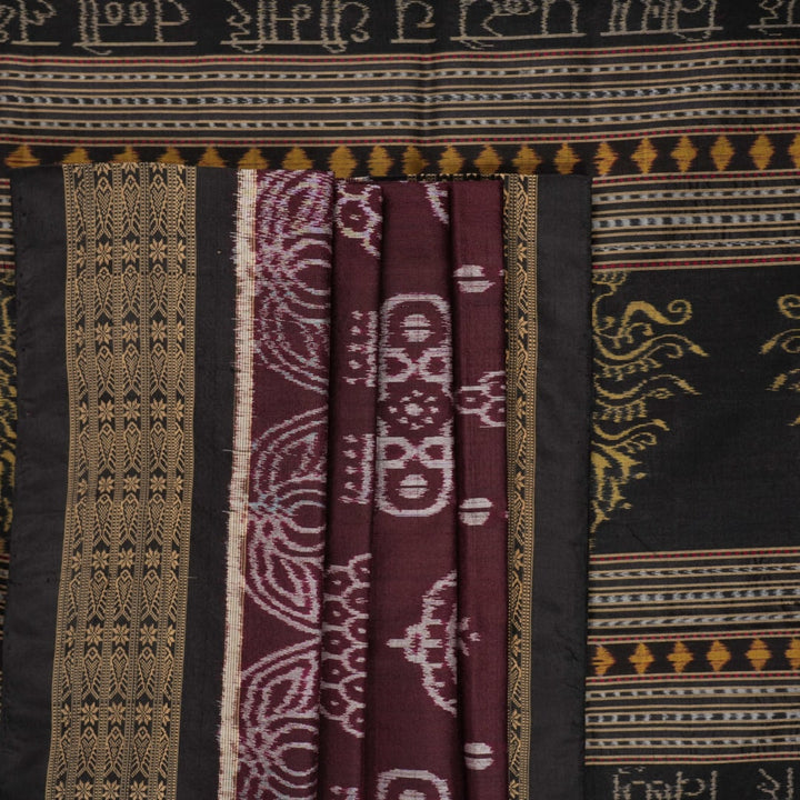 Micro close-up of the maroon Sambalpuri silk fabric, revealing its luxurious texture and handloom weave.