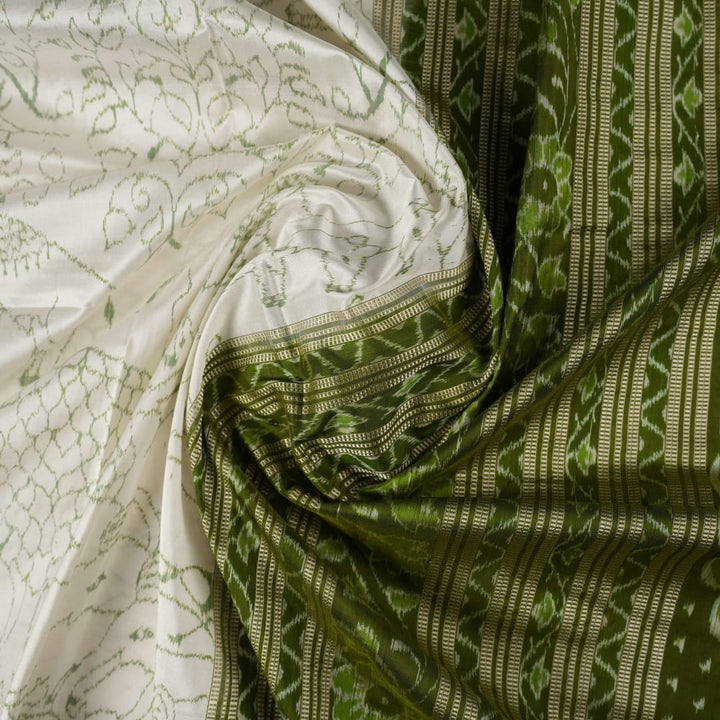 Close-up of the luxurious texture of the white Sambalpuri Silk Saree, revealing the fine weave and motif details.