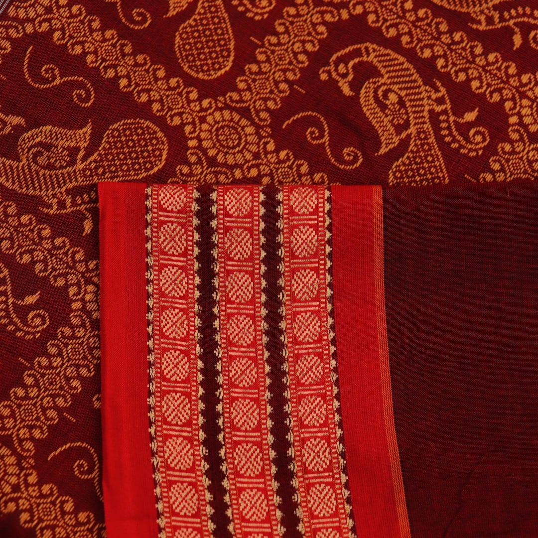 Full view of a black cotton Bomkai saree with rust-colored butta patterns and pallu.