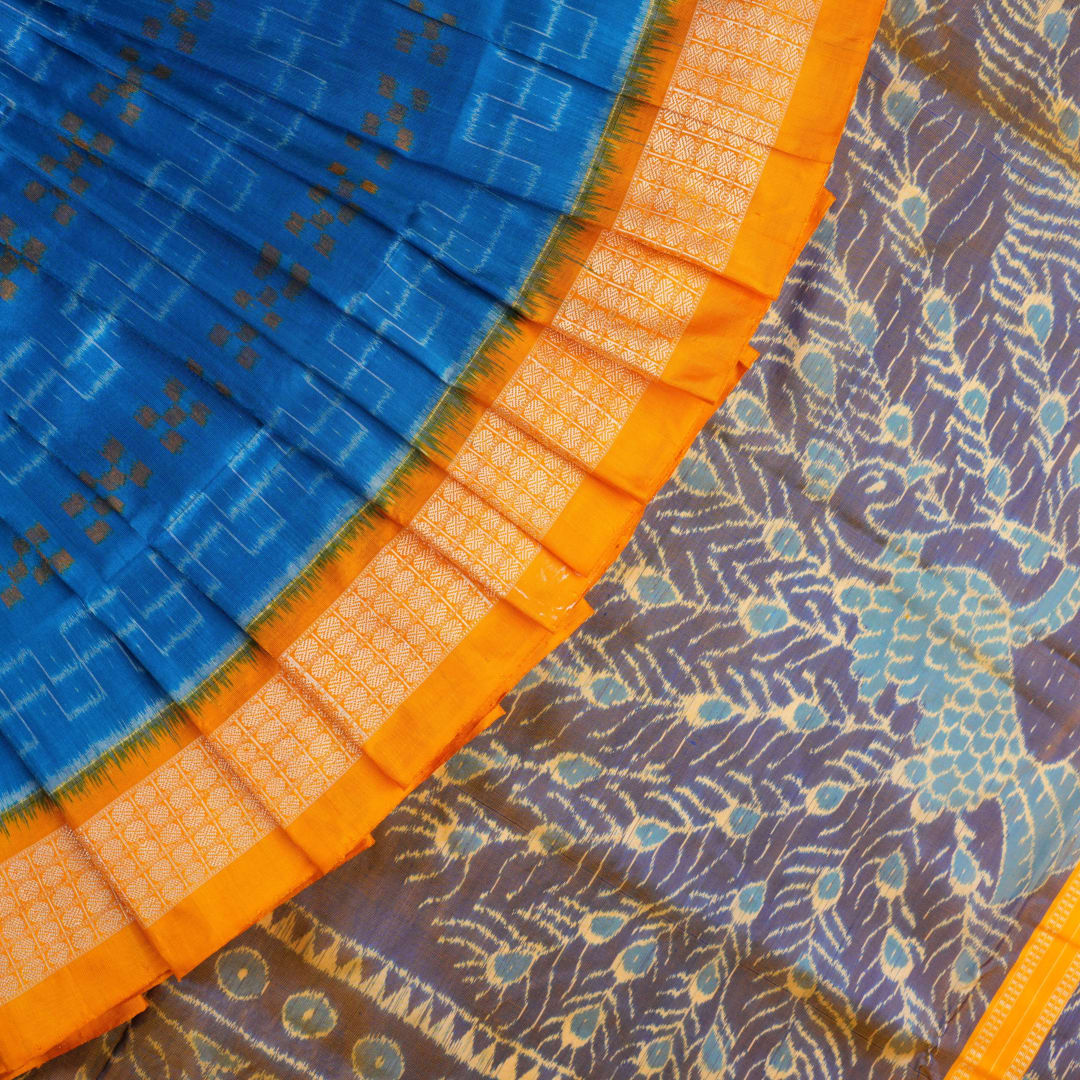 Close-up of the luxurious Sambalpuri silk fabric, highlighting its rich texture and handloom weave in blue and yellow.