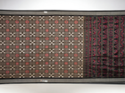 Close-up of the luxurious silk fabric texture and handloom weave of the grey and black Sambalpuri saree.