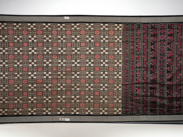 Close-up of the luxurious silk fabric texture and handloom weave of the grey and black Sambalpuri saree.