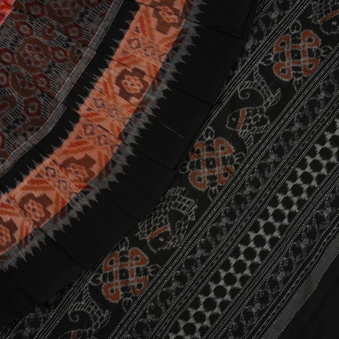 Full layout of the orange and black Sambalpuri cotton saree displaying the complete pattern and design.