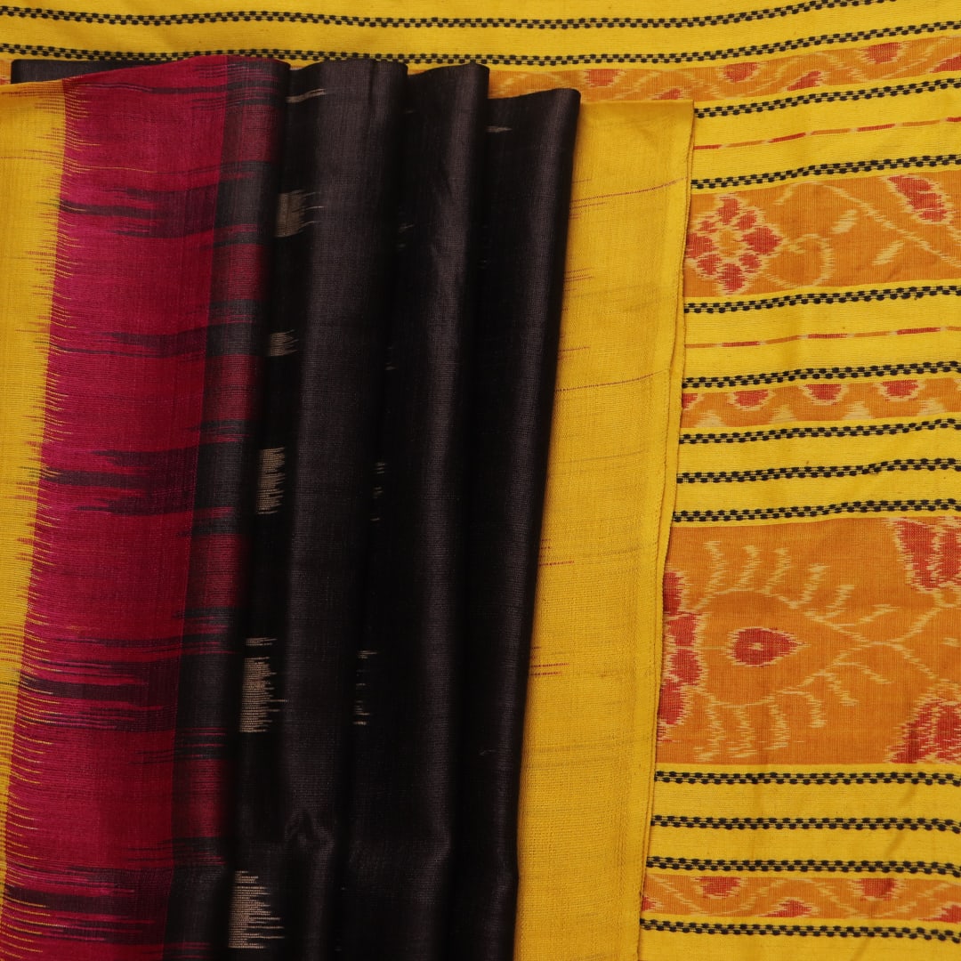 Close-up of black and gold Tussar silk saree fabric with intricate motif patterns