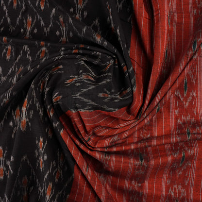 Elegant model styling of a black and orange Sambalpuri cotton saree showcasing the complete handloom look.