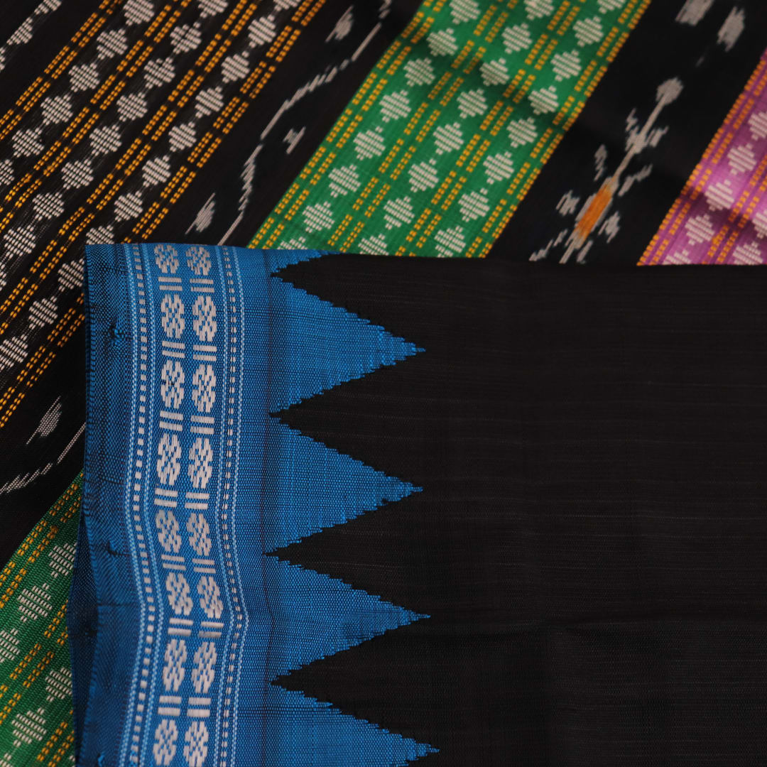 Close-up of intricate butta pattern on a silk blue and black Berhampuri saree