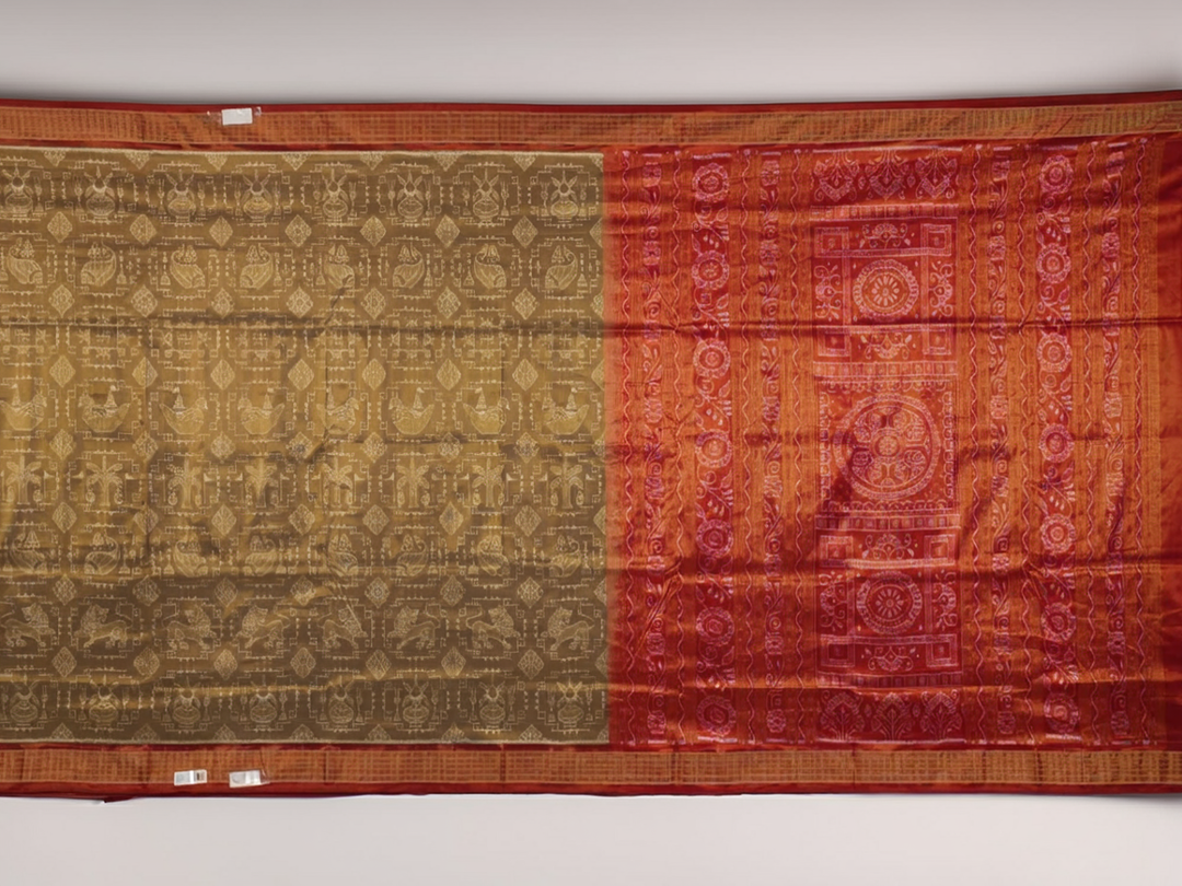 Ultra close-up of Sambalpuri silk saree fabric, showing luxurious texture and tissue motif weave.