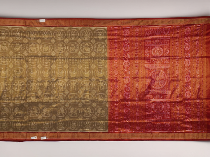 Ultra close-up of Sambalpuri silk saree fabric, showing luxurious texture and tissue motif weave.