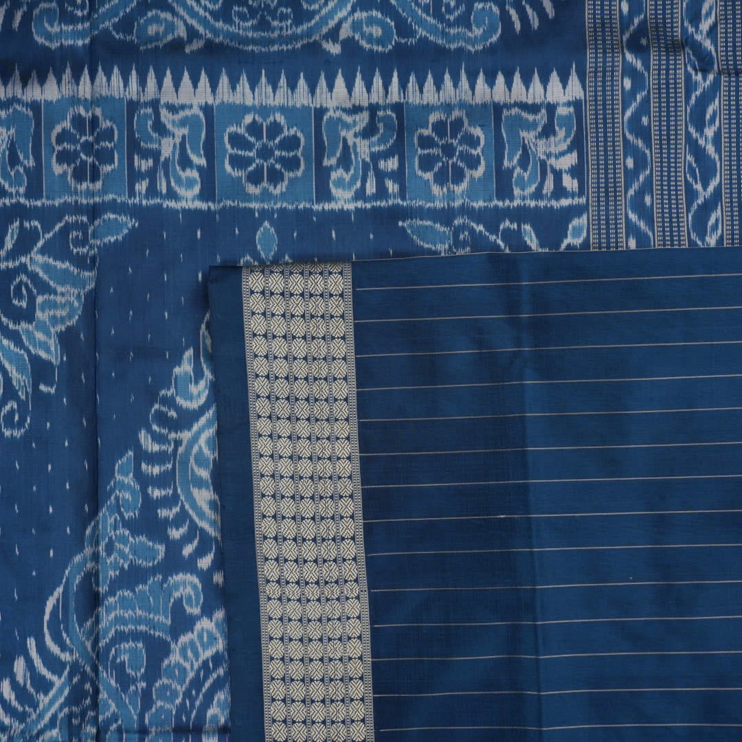 Close-up of premium fabric texture and handloom weave on a white and blue Sambalpuri silk saree