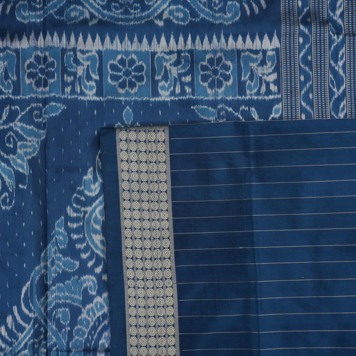 Close-up of premium fabric texture and handloom weave on a white and blue Sambalpuri silk saree