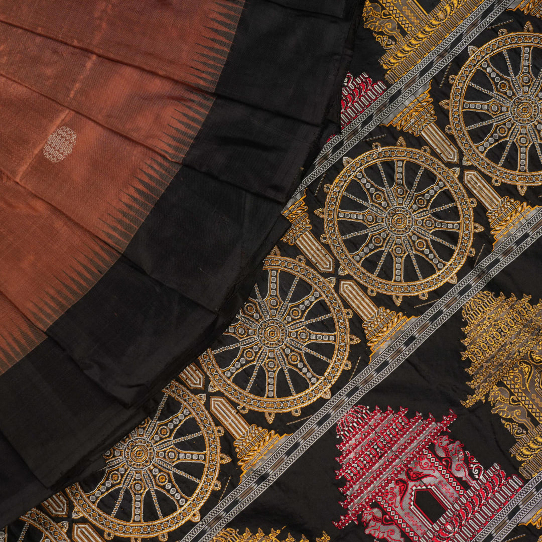 Extreme close-up of brown Bomkai silk saree fabric, revealing rich weave texture and luxurious feel.