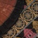 Extreme close-up of brown Bomkai silk saree fabric, revealing rich weave texture and luxurious feel.