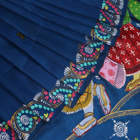 Close-up of handloom blue silk Patachitra saree fabric, showcasing the fine texture and hand-painted details.