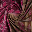 Model wearing an elegantly draped maroon and brown Sambalpuri cotton saree with traditional ikat motifs.