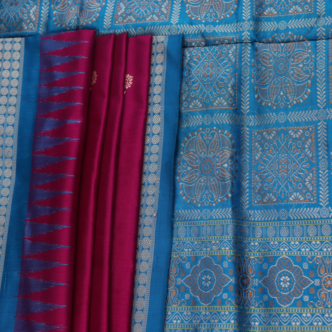 Close-up of Bomkai silk saree's textured weave, featuring magenta, blue, and butta pattern.