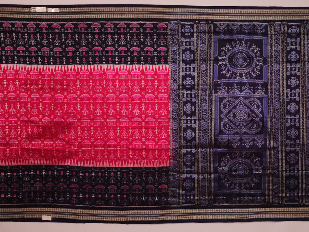 Close-up showing the intricate silk fabric texture of a magenta Sambalpuri saree with multicolor motifs.