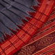 Grey Khandua silk saree styled and draped, showcasing the plain body and red border.