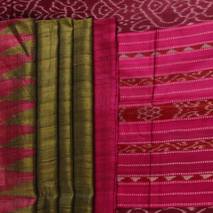 Close-up view of the luxurious texture of a plain green Tussar silk saree with a magenta border