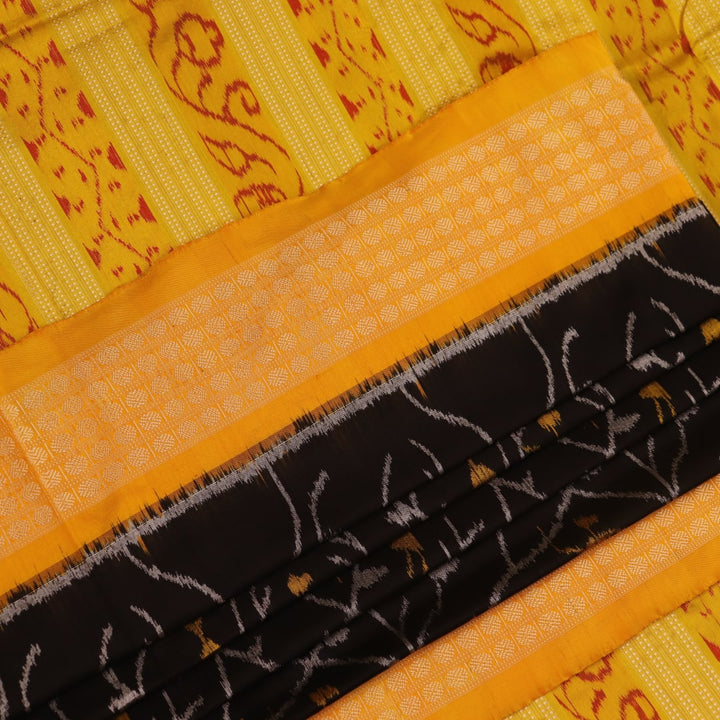 Close-up showcasing intricate silk fabric texture in black and yellow motifs