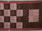 Off-white Sambalpuri cotton saree with green motifs, elegantly draped.