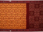 Yellow and maroon Sambalpuri cotton saree with motifs, draped elegantly to showcase its design.