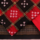 Detail of the black Sambalpuri cotton Pasapalli dress material's blouse piece with red accents.