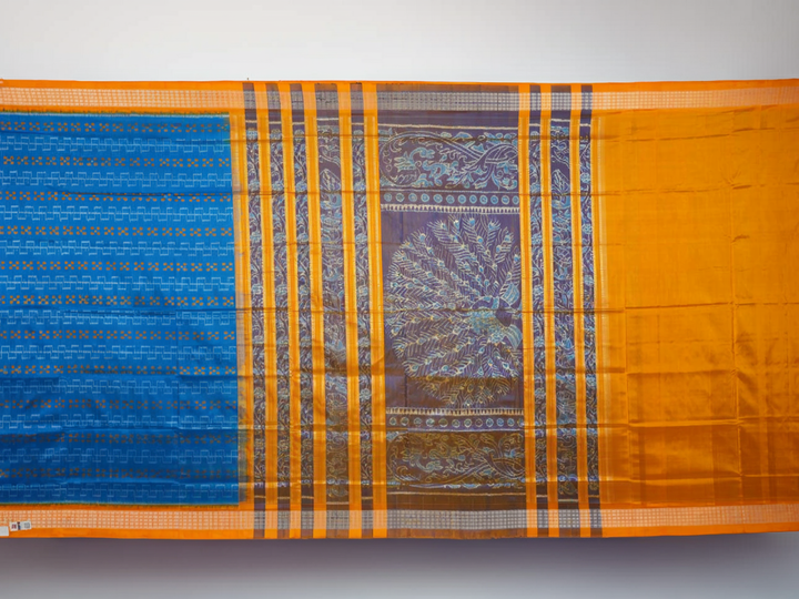Close-up of the luxurious Sambalpuri silk fabric, highlighting its rich texture and handloom weave in blue and yellow.