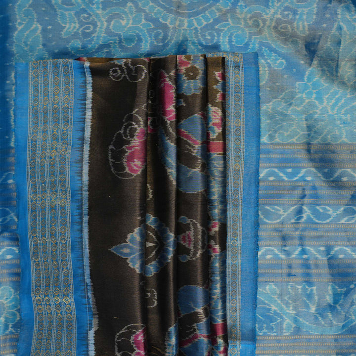 Close-up of Sambalpuri silk saree fabric, revealing rich blue multi-color weave texture and tissue motifs.
