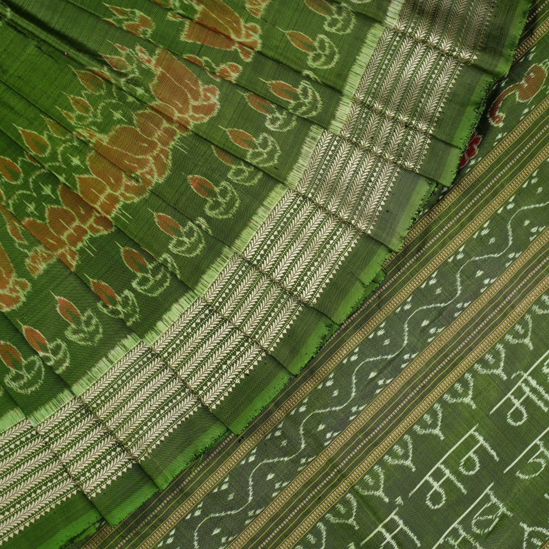 Ultra close-up of green Sambalpuri silk fabric, revealing its unique texture and fine weave.