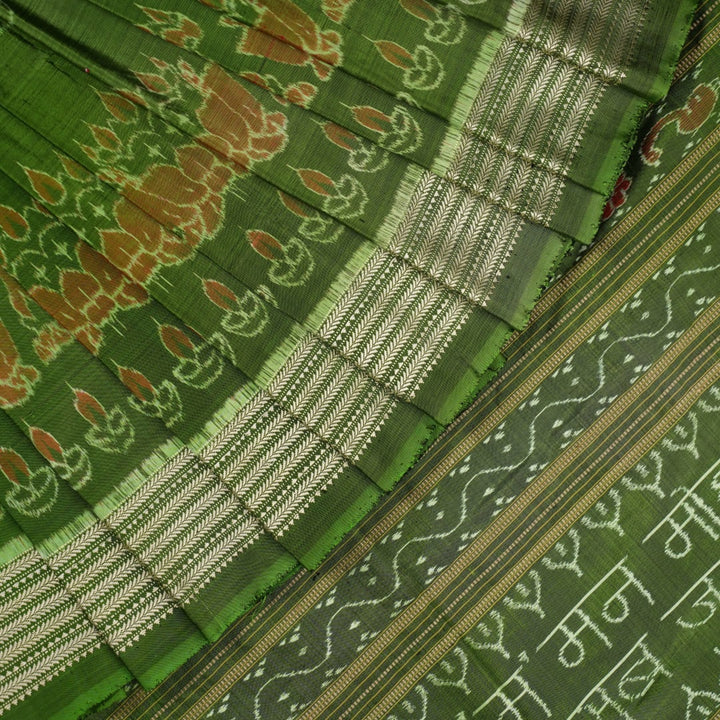 Ultra close-up of green Sambalpuri silk fabric, revealing its unique texture and fine weave.