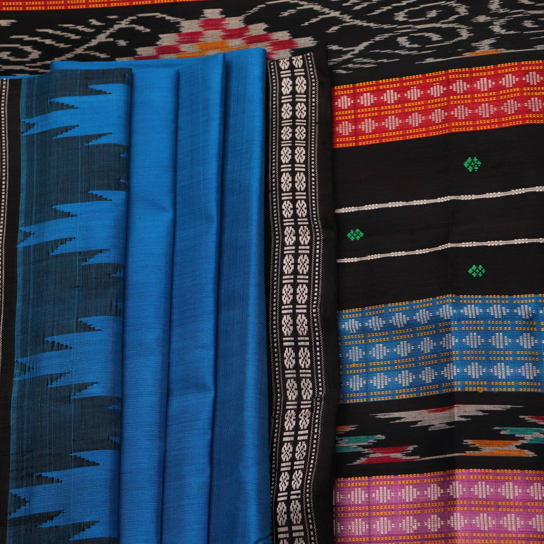 Close-up of intricate butta pattern on a silk blue and black Berhampuri saree