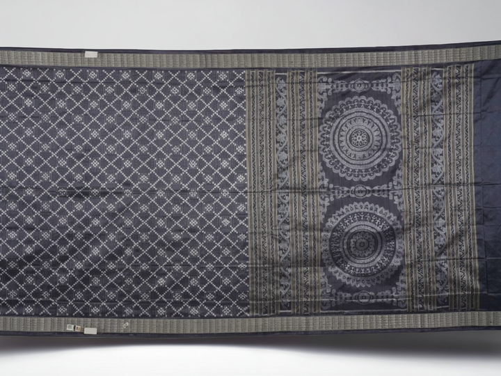 Close-up of the soft, luxurious grey Sambalpuri silk fabric texture with subtle weave details.